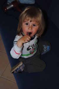 Portrait of cute girl sitting on sofa