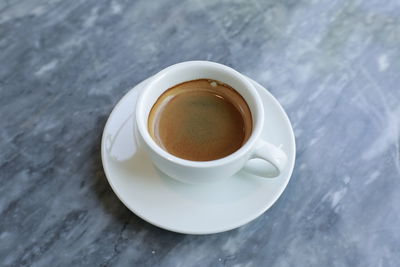 High angle view of coffee cup on table