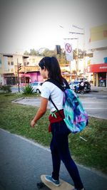 Woman standing on road in city