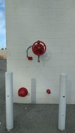 Red umbrella against brick wall