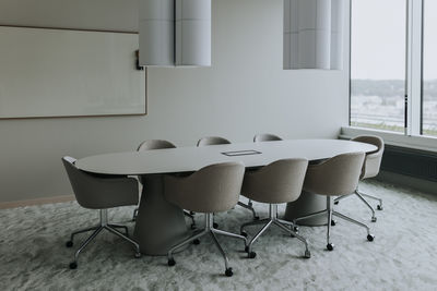 Empty conference table with chairs in board room