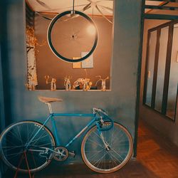 Bicycle hanging on wall at home
