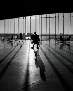 Silhouette people walking at airport