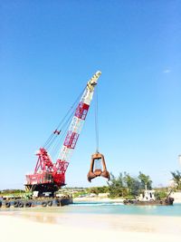 Crane against clear blue sky