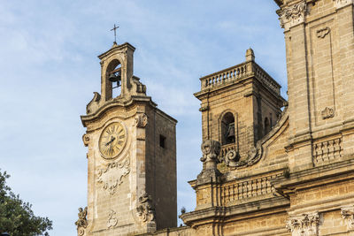 Low angle view of clock tower against sky