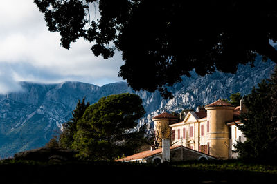 Buildings against cloudy sky