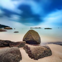 View of rocks on beach against sky