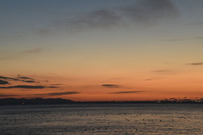 Scenic view of sea against romantic sky at sunset