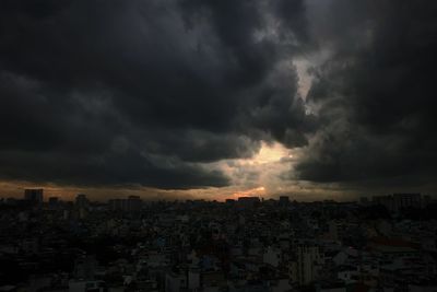 Aerial view of city against dramatic sky
