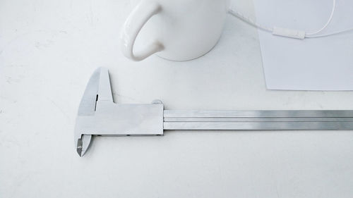 Caliper and cup on white background