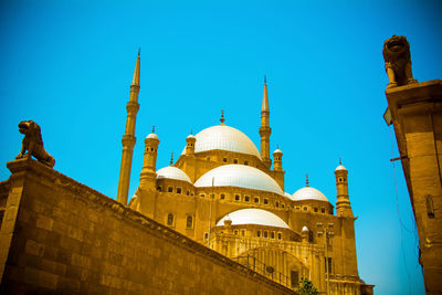 Low angle view of building against clear blue sky