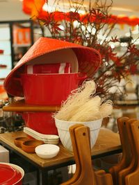 Food and crockery with asian style conical hat on restaurant table