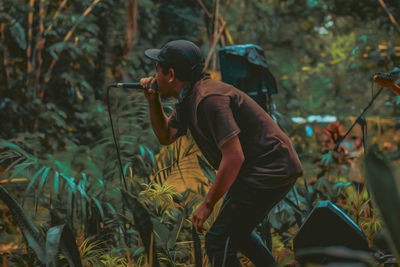 Midsection of man in forest