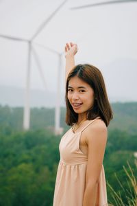 Portrait of a smiling young woman standing outdoors