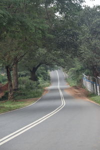 Road amidst trees in forest