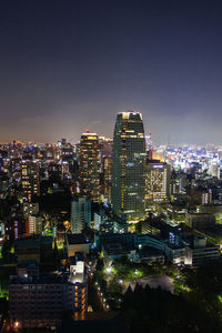 High angle view of illuminated buildings in city at night