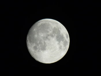 Low angle view of moon against dark sky