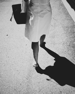 Low section of woman standing on ground