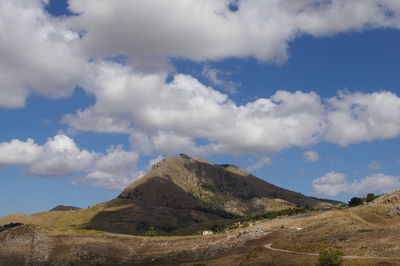 Scenic view of mountains against blue sky