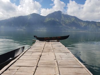 Scenic view of pier in lake against sky