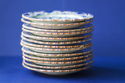 Close-up of bowls on blue background
