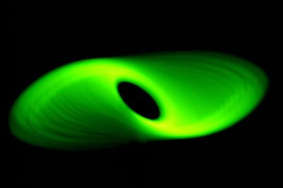 Close-up of green toy over black background