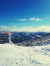 Scenic view of landscape against blue sky during winter