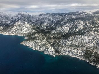 Aerial view of sea and mountains against sky