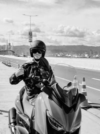 Rear view of man riding motor scooter on beach