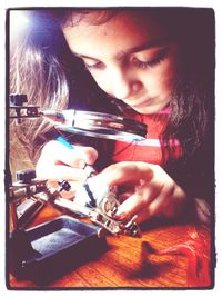 Close-up of woman holding camera
