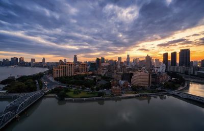 View of cityscape against cloudy sky during sunset