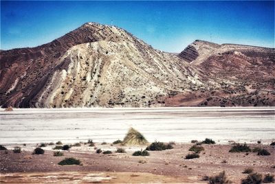 View of arid landscape against clear sky