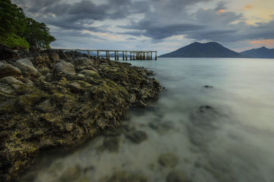 Scenic view of sea and mountains against sky