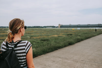 Rear view of blonde woman looking at road