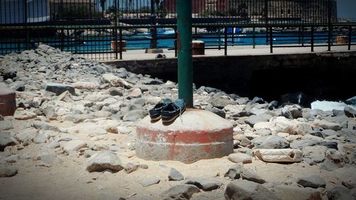 Pair of shoe on pole at sea shore