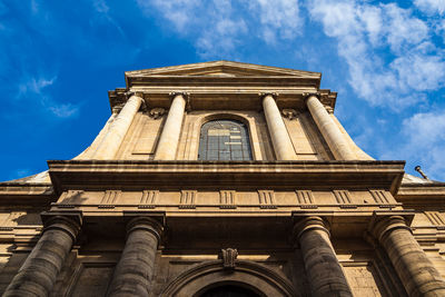 Low angle view of historical building against cloudy sky