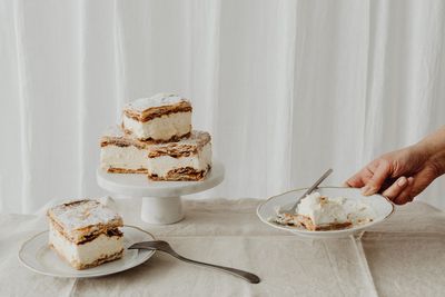 Cropped hand of woman holding cake