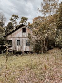 Abandoned house on field against sky