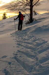 Man skiing on snow covered field