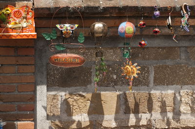 Low angle view of decoration hanging against wall