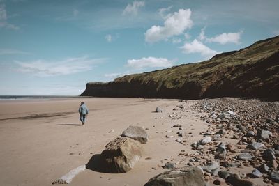 Man on beach against sky