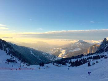 Scenic view of snowcapped mountains during sunset