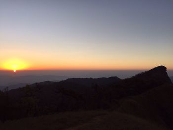 Scenic view of silhouette trees against clear sky during sunset