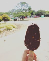 Close-up of hand holding ice cream cone