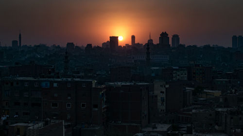 Cityscape against sky during sunset