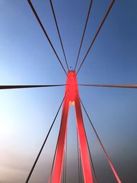 Low angle view of illuminated bridge against blue sky