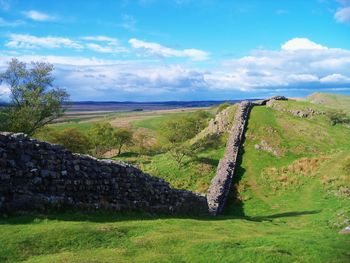 Scenic view of landscape against cloudy sky
