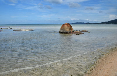 Scenic view of sea against cloudy sky