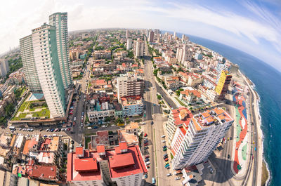 High angle view of city by sea against sky