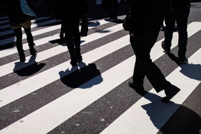 Low section of people walking on street